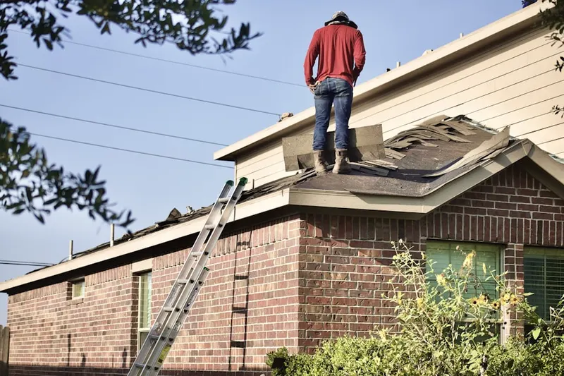 Professional roofer working on a residential roof in Sabre Springs